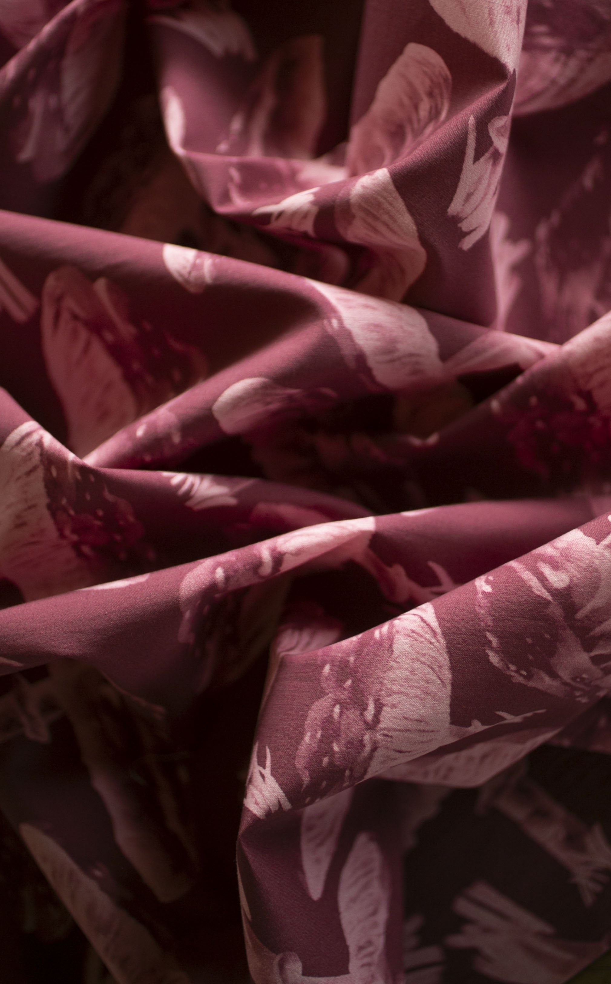 Close-up of LIBE printed silk, folded to catch the light